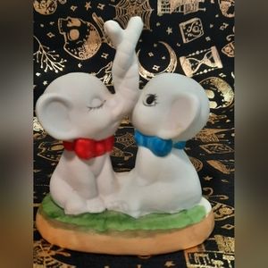 Twisted trunks kissing elephants